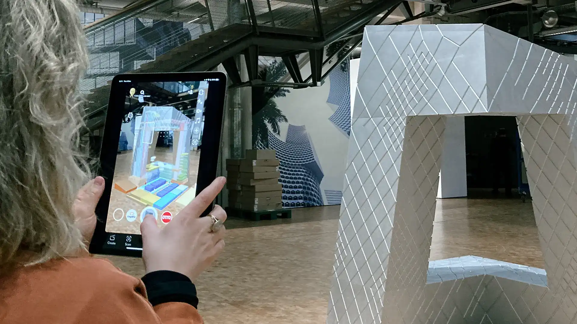 Person viewing an augmented Architecture model through an iPad