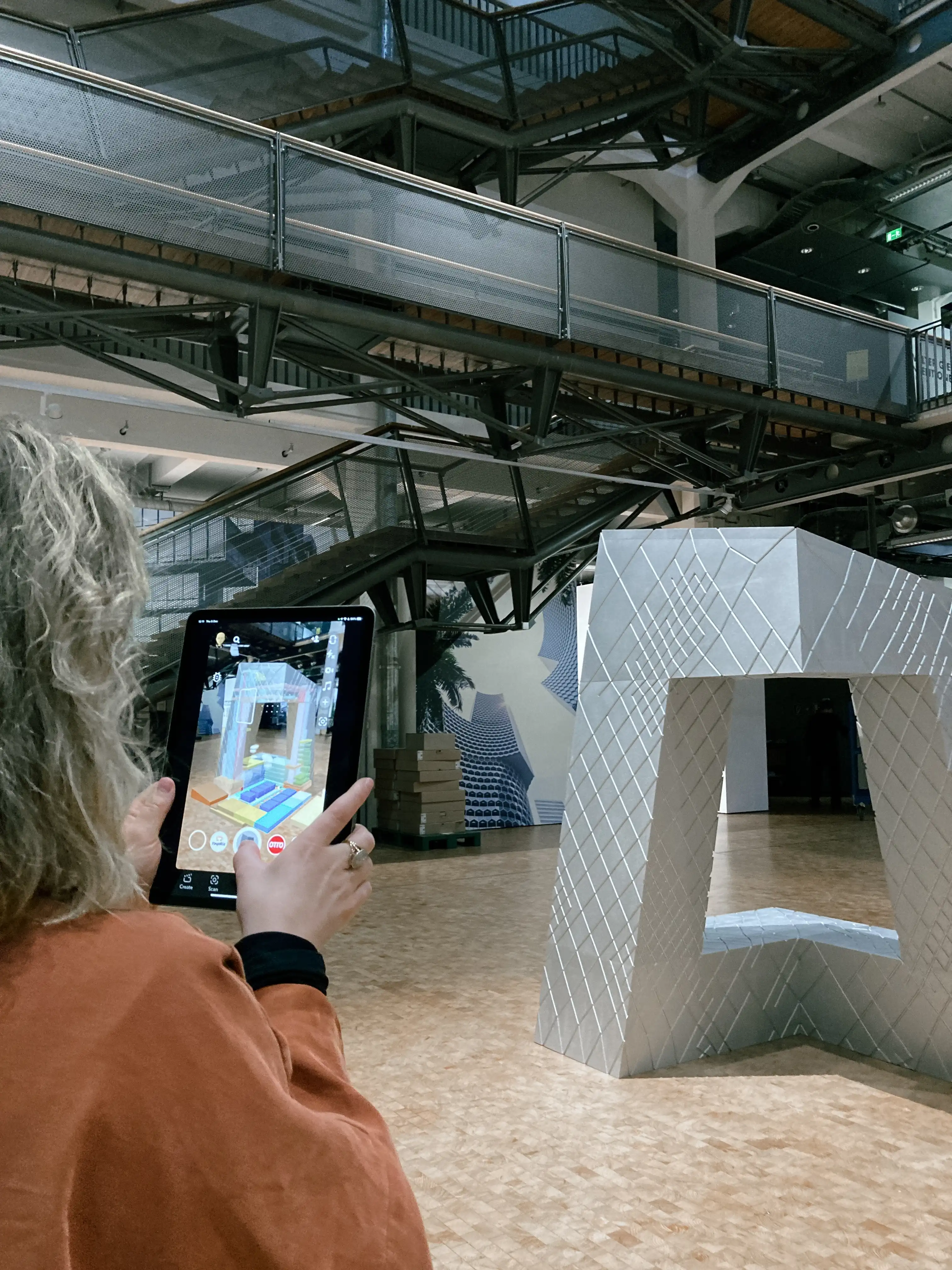 person viewing an a model of a building through an iPad with AR filter 